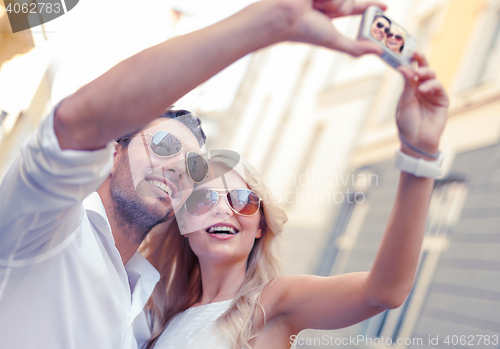 Image of travelling couple taking photo picture with camera