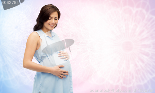 Image of happy pregnant woman touching her big belly