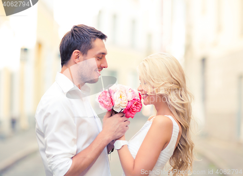 Image of couple with flowers in the city