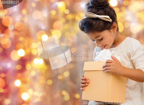 Image of smiling little girl with gift box