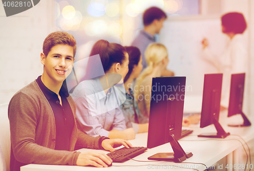 Image of students with computer monitor at school