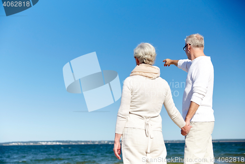 Image of happy senior couple on summer beach