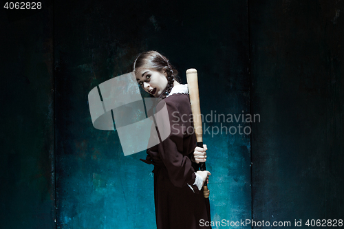 Image of Portrait of a young girl in school uniform as killer woman