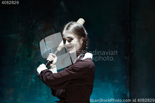 Image of Portrait of a young girl in school uniform as killer woman