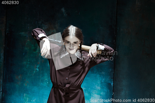 Image of Portrait of a young girl in school uniform as killer woman