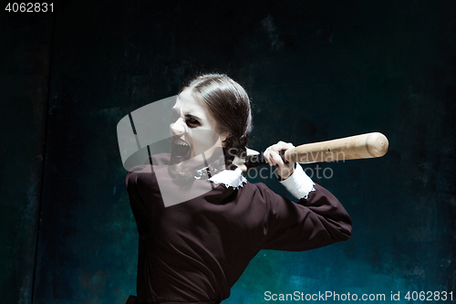 Image of Portrait of a young girl in school uniform as killer woman