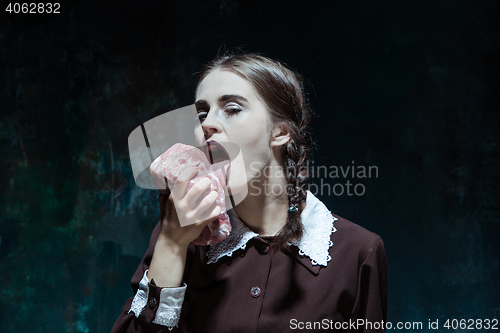 Image of Bloody Halloween theme: crazy girl with raw meat