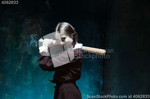 Image of Portrait of a young girl in school uniform as killer woman