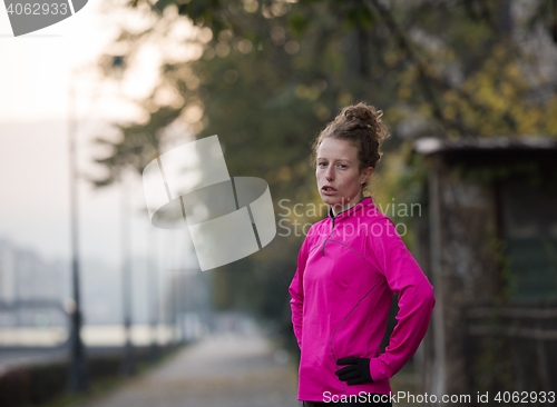 Image of woman  stretching before morning jogging