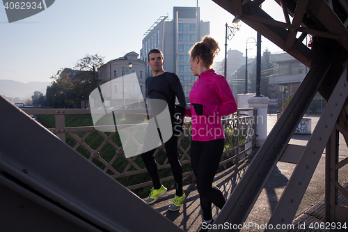 Image of woman  stretching before morning jogging