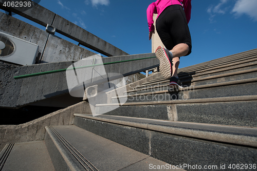 Image of woman jogging on  steps