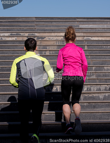 Image of young  couple jogging on steps