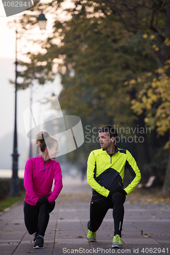 Image of couple warming up before jogging