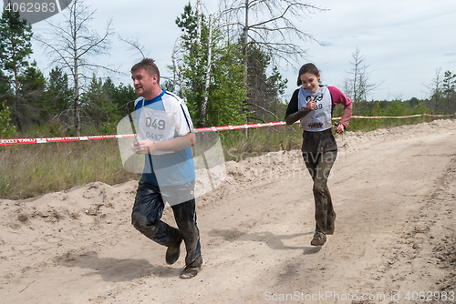 Image of Athletes run between stages in extrim race.Tyumen