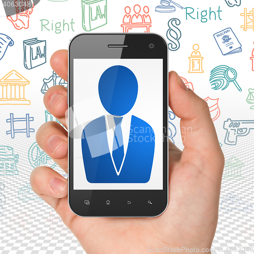 Image of Law concept: Hand Holding Smartphone with Business Man on display