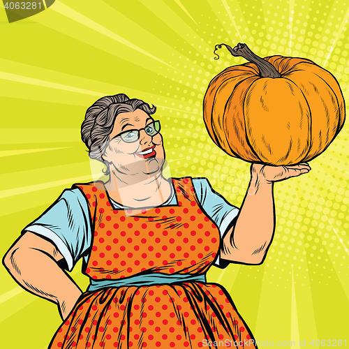 Image of Cheerful grandmother with pumpkin for Thanksgiving