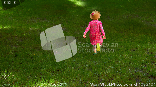Image of Happy cute little girl running in the park. Happiness.