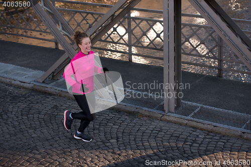 Image of sporty woman jogging on morning