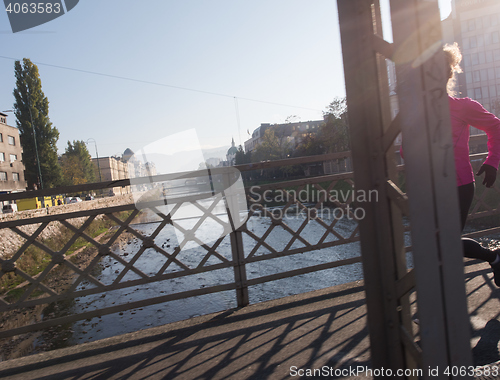 Image of sporty woman jogging on morning