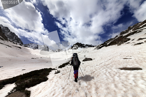 Image of Hiker in snow mountain at sun day