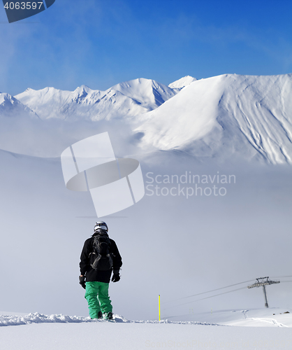 Image of Snowboarder on snowy slope with new fallen snow