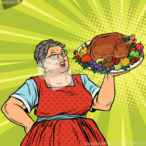 Image of Grandma with a Christmas or Thanksgiving roast Turkey