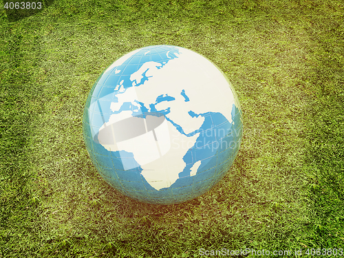 Image of earth on a green grass. 3D illustration. Vintage style.