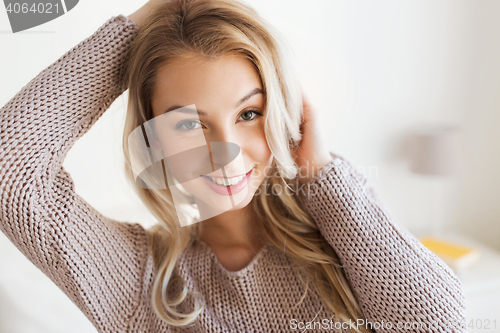 Image of happy young woman or teenage girl at home
