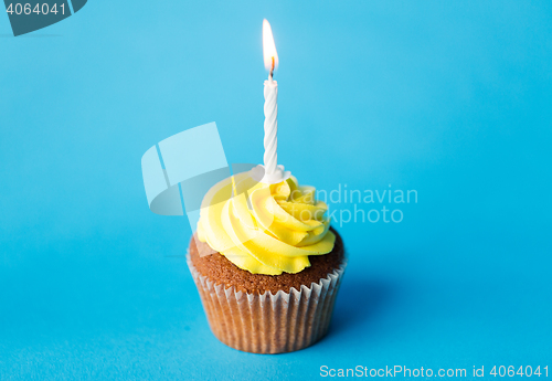 Image of birthday cupcake with one burning candle