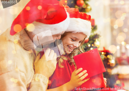 Image of smiling father and daughter opening gift box