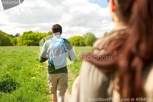 Image of close up of couple with backpacks hiking outdoors