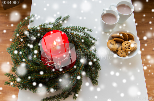 Image of close up of christmas wreath with candle on table