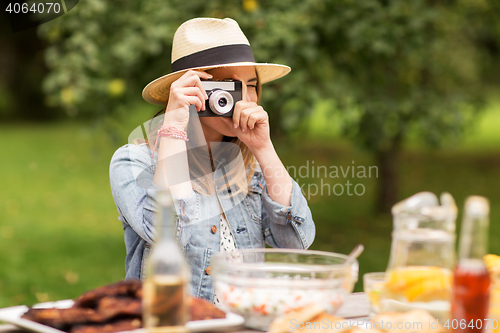 Image of close up of woman with camera shooting outdoors