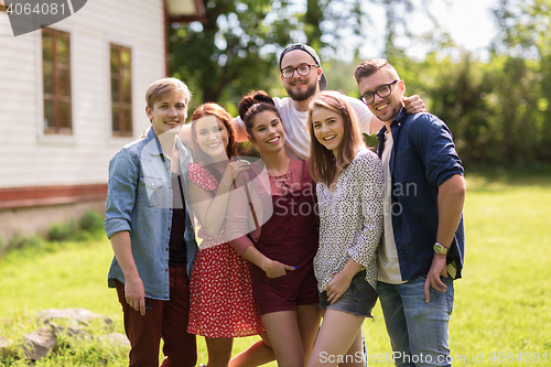 Image of happy teenage friends hugging at summer garden