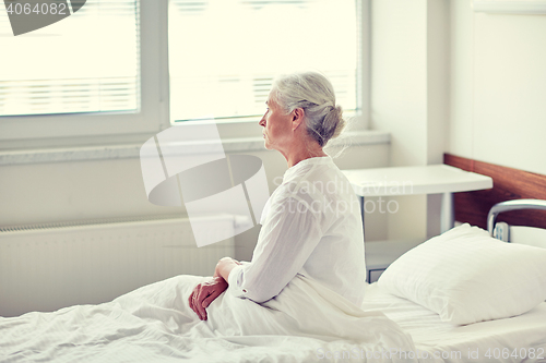 Image of senior woman patient lying in bed at hospital ward