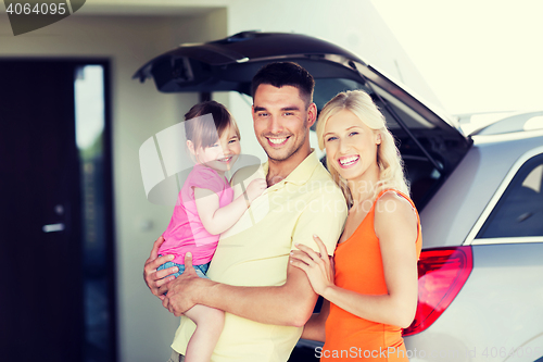 Image of happy family with hatchback car at home parking