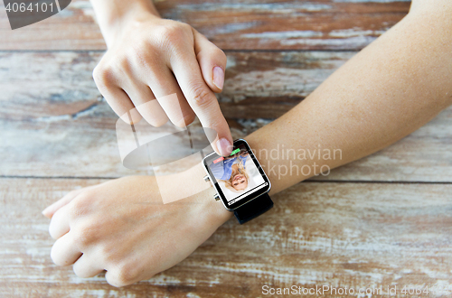 Image of close up of hands with incoming call on smartwatch
