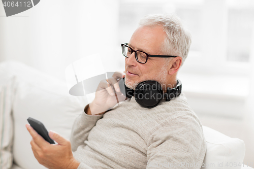 Image of happy senior man with smartphone and headphones