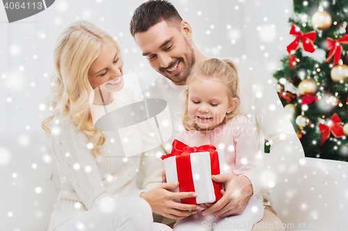 Image of happy family at home with christmas gift box