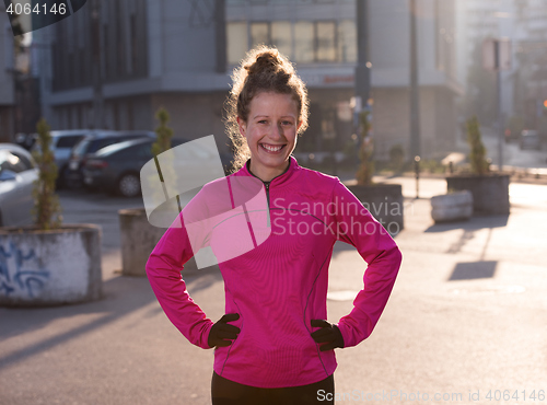 Image of woman  stretching before morning jogging