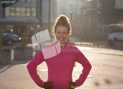 Image of woman  stretching before morning jogging