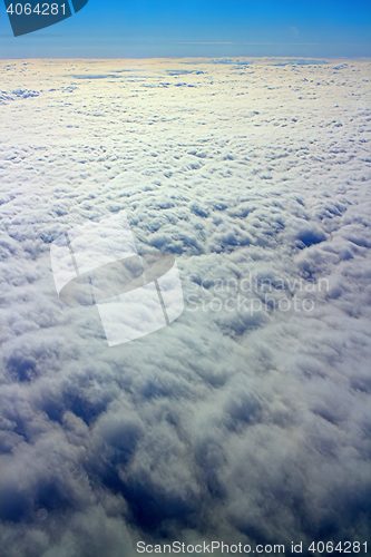 Image of Clouds pass under wing of plane