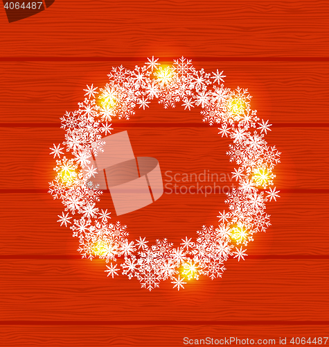 Image of Christmas circle frame made in snowflakes on red wooden backgrou