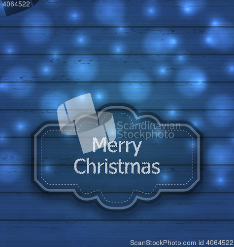 Image of Christmas label on wooden texture with light