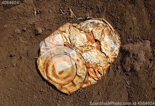 Image of Old crushed rusty tin can