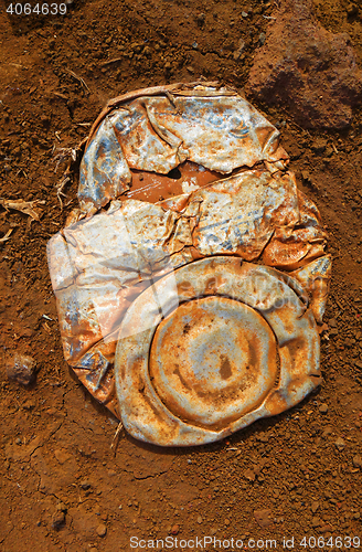 Image of Old crushed rusty tin can