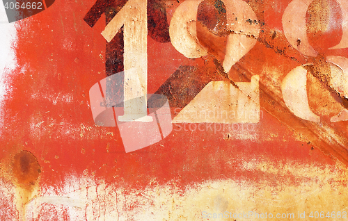 Image of old rusty painted metal wall with numbers