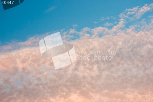 Image of Yellow and orange clouds on blue sky