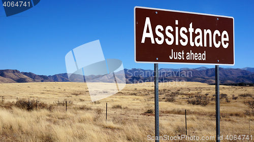 Image of Assistance brown road sign