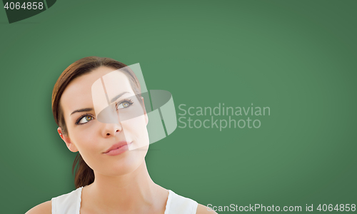 Image of Attractive Young Woman Looking Up to Blank Chalk Board